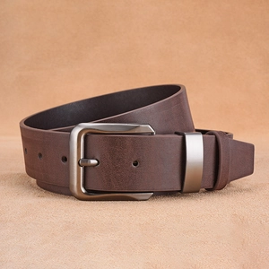 Close-up of a dark brown faux leather men's belt with a matte silver metal pin buckle