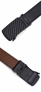 Detail of automatic buckle with carbon fiber texture and Greek key pattern on leather belt