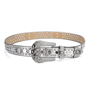 Detail of punk style silver belt with skull buckle and sparkling rhinestone studs