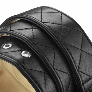Gros plan d'une ceinture en cuir matelassé noir avec œillets argentés et motif diamant