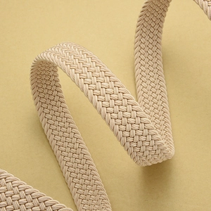 Close-up of beige woven elastic belt showcasing dense cross-braid texture and flexible material