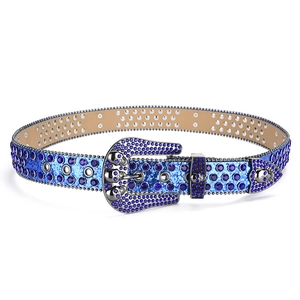 Detail of western punk belt featuring blue rhinestones and silver skull metal buckle
