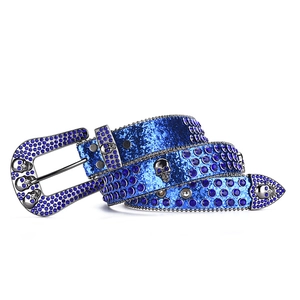 Detail of blue punk belt featuring sparkling rhinestones and silver skull metal buckle