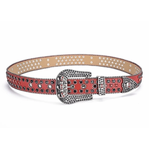 Close-up of a punk red leather belt with silver skull buckle and red sparkling rhinestones