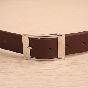 Detail view of a men's dark brown leather belt with a silver metal prong buckle and stitching
