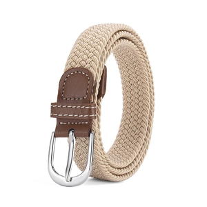 Detail of beige woven elastic belt with brown leather trim and silver D-ring buckle