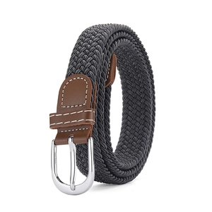 Detail of grey elastic woven belt featuring brown leather patches and silver pin buckle