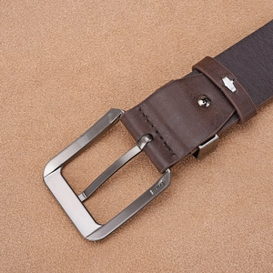 Detailed macro shot of dark brown faux leather belt with matte grey buckle and H4172 engraving