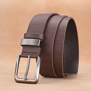 Detail of dark brown leather belt featuring a gunmetal brushed metal pin buckle