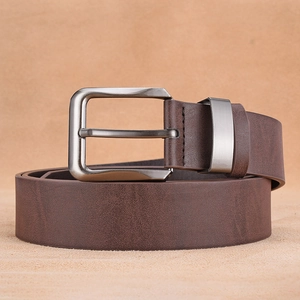 Close-up of a dark brown faux leather belt with a brushed silver metal pin buckle