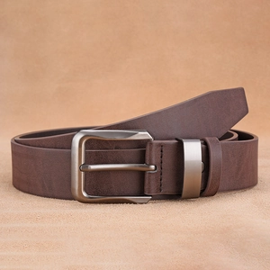 Detailed view of dark brown faux leather belt with a silver-grey metal pin buckle