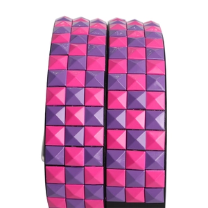 Y2K punk style belt featuring pink and purple checkered pyramid studs on black band