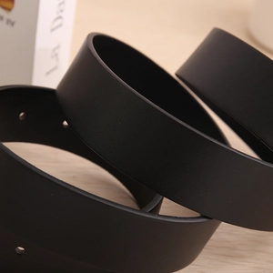 Macro shot showing the smooth texture and precise hole details of a black leather belt
