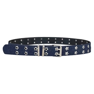 Detailed close-up of dark blue denim belt with silver star-shaped eyelets and metal buckle