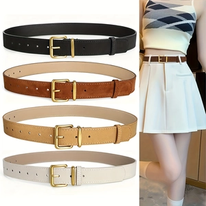 Variety of women suede belts with vintage brass buckles in four colors on a white skirt
