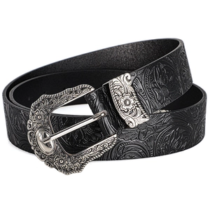 Close-up of vintage black leather belt featuring floral embossing and engraved silver buckle