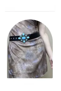 Detail of bohemian black leather belt featuring a large turquoise inlay vintage alloy buckle