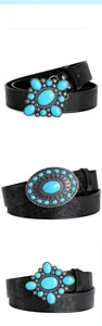 Detail view of Bohemian embossed black leather belts with vintage turquoise buckle styles