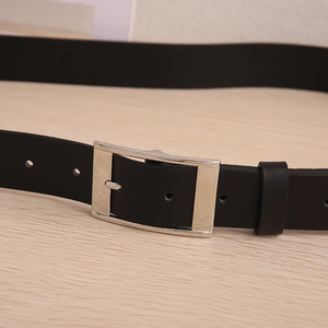 Close-up of men's black leather belt featuring a classic silver square pin buckle detail
