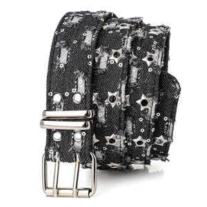 Detail view of punk denim belt with star rivets and metallic double pin buckle