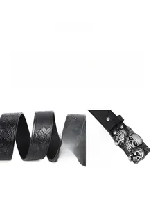 Detail of black leather belt featuring floral embossed texture and twin skull metal buckle