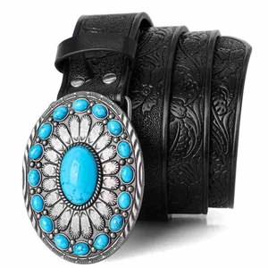 Detail of western retro black leather belt with embossed floral pattern and turquoise buckle
