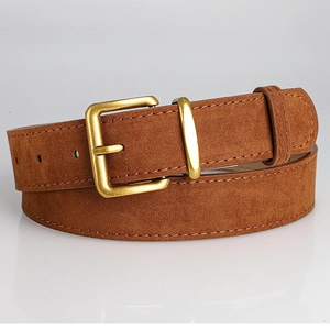 Close-up of brown suede belt featuring a vintage brass buckle and fine stitching detail