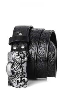 Detail of bohemian punk leather belt with vintage skull buckle and floral embossing