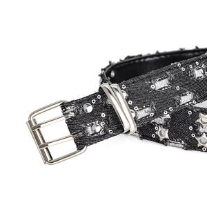 Detail of Y2K punk style black denim belt with silver star eyelets and double prong buckle
