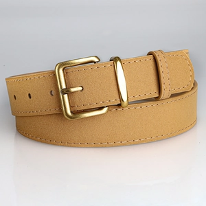 Detail of light brown suede belt with vintage bronze buckle and white stitching accents