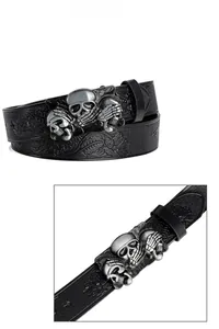 Detail of bohemian belt with three skulls buckle and floral embossed leather texture