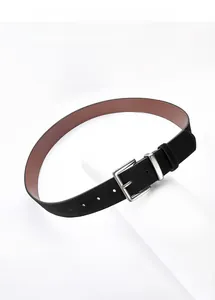 Detail of vintage suede belt with brushed silver buckle on minimalist white stand