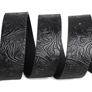 Close-up of vintage Western style belt featuring floral embossed patterns and leather texture