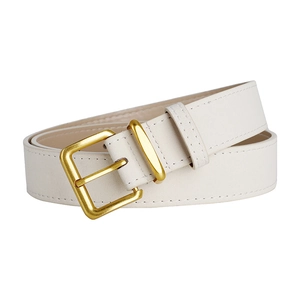 Detail of minimalist ivory suede belt with golden pin buckle and refined stitching