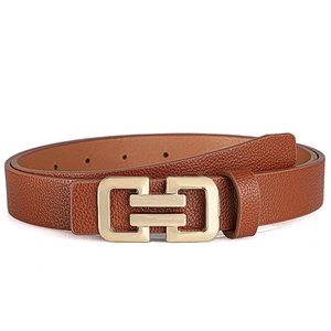 Detail of brown leather belt with lychee texture and golden geometric buckle closure