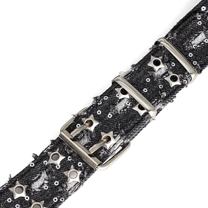 Detail of black denim punk belt with silver sequins and star-shaped metal eyelets