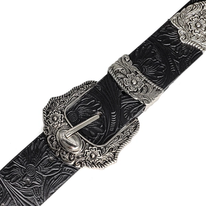 Close-up of black leather belt featuring floral embossing and carved silver metal buckle