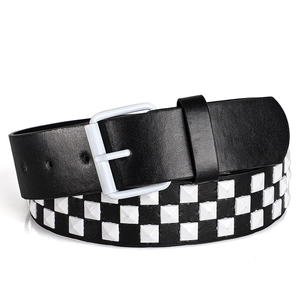 Detail of Y2K punk rock belt with white square studs on black leather strap and pin buckle