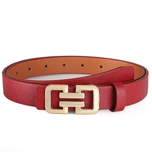 Close-up of red lychee pattern leather belt with golden interlocking double ring buckle
