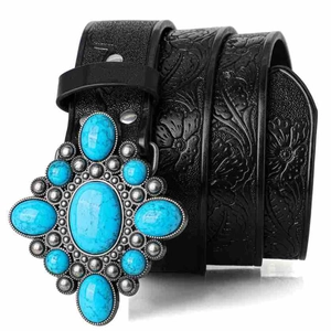 Detailed macro view of bohemian black embossed leather belt with turquoise buckle