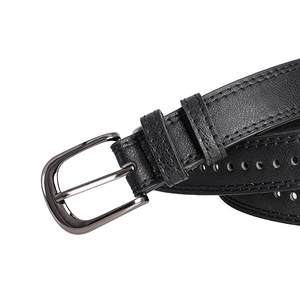 Close-up of black leather belt featuring lychee texture and gunmetal buckle