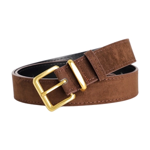 Detail of premium brown suede leather belt with polished gold pin buckle on white background