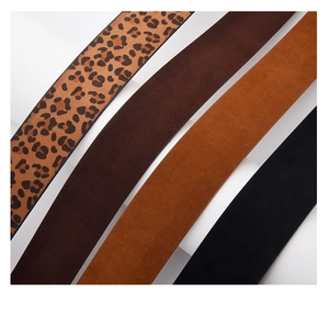 Detail of four suede belts in leopard, brown, tan, and black with velvet texture
