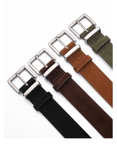 Detail of four matte suede belts with vintage silver pin buckles in earthy tones