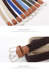 Detail view of multicolored woven elastic belts with leather tips and metal buckles