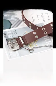 Detail of dark brown leather punk belt with double silver eyelets and metal chain