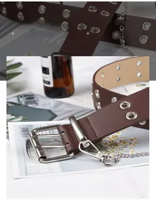 Close-up of punk style dark brown leather belt with silver double grommets and metal chain