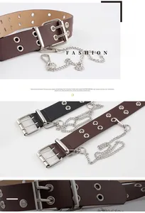 Detail view of punk style leather belts with double grommets and metal chains