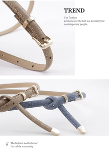 Détail d'une fine ceinture en simili lézard avec boucle ardillon dorée chic