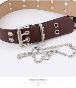 Close-up of a dark brown punk belt featuring double metal eyelets and a silver chain